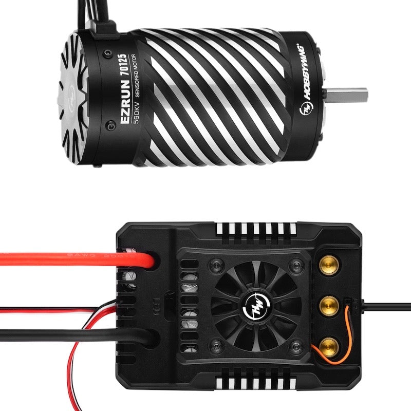 Black and silver motor with a speed controller with red and black wiring on a white background