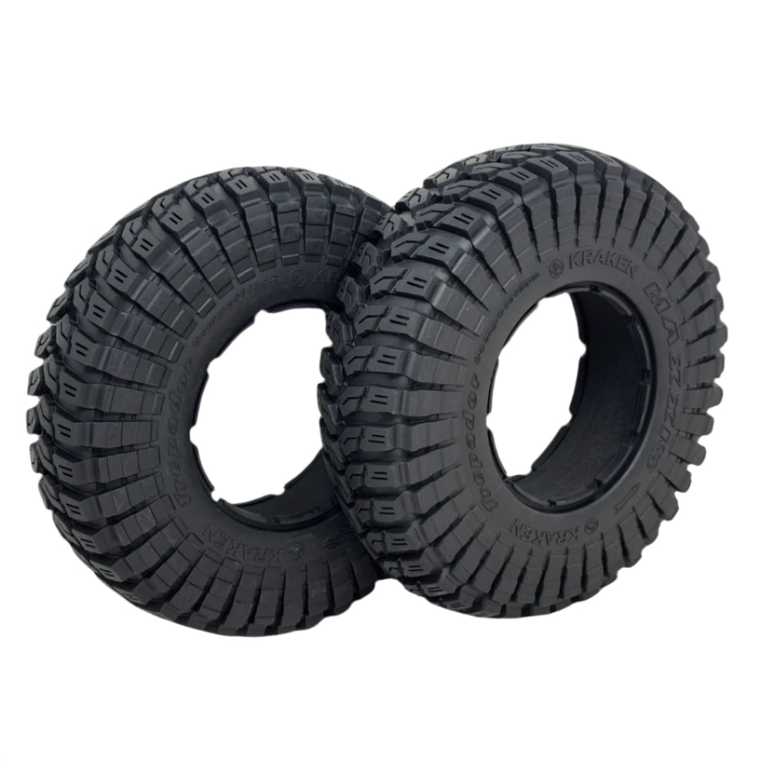 Two black off-road tires with tread pattern on a white background