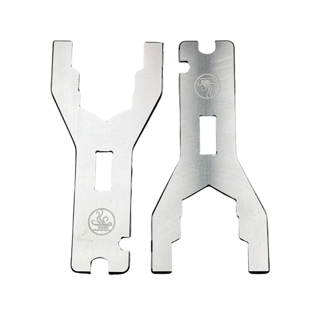 Two metal tools with a logo on a white background