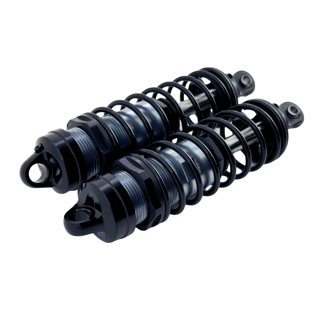 Two black shock absorbers on a white background