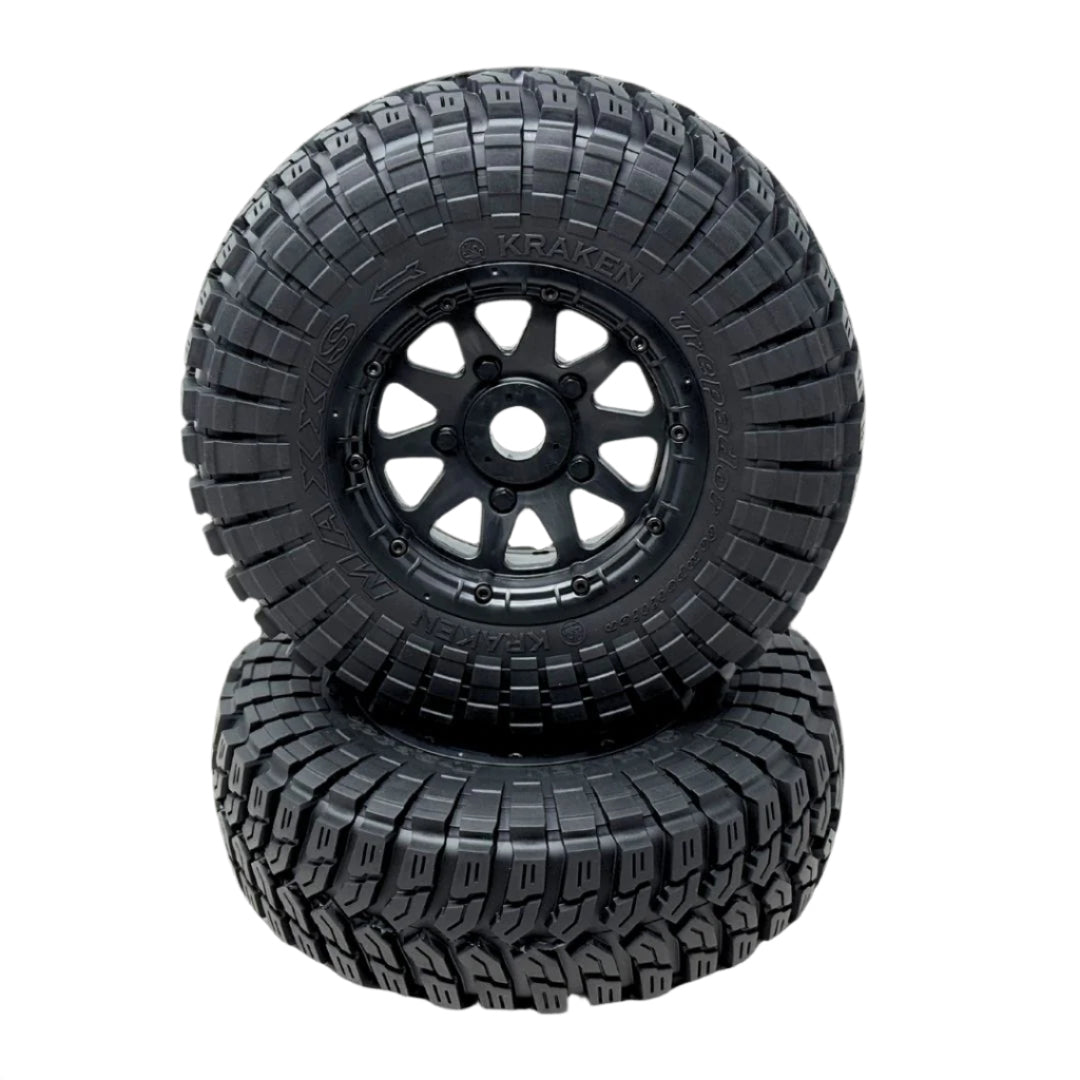 Two black off-road tires with tread patterns on a transparent background