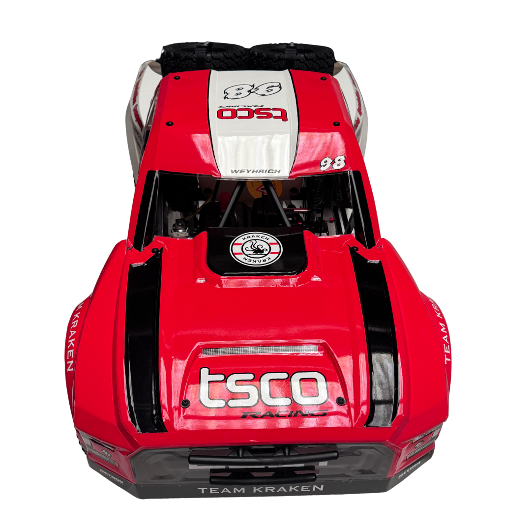Red and black model car with visible branding on a white background