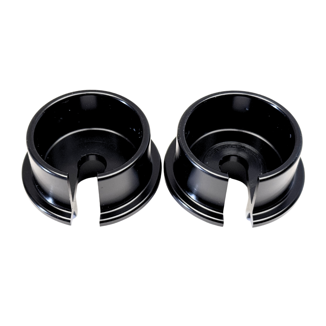 Two black metal bushings on a white background