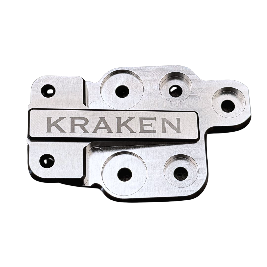 Metal component with 'Kraken' engraving on a white background