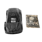 Black plastic car seat base with clear cover and additional packaging on a white background
