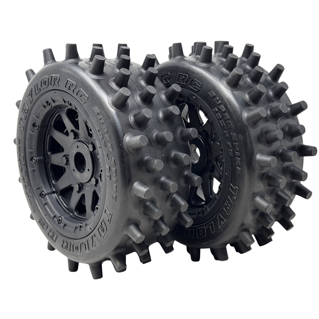 Two Taylor RC tires with spiky tread pattern on a white background