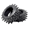 Two black off-road tires with spiky tread pattern on a white background